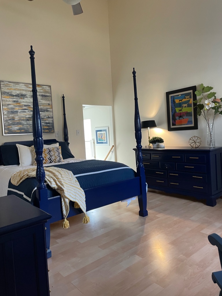 Coastal bedroom with restored navy furniture