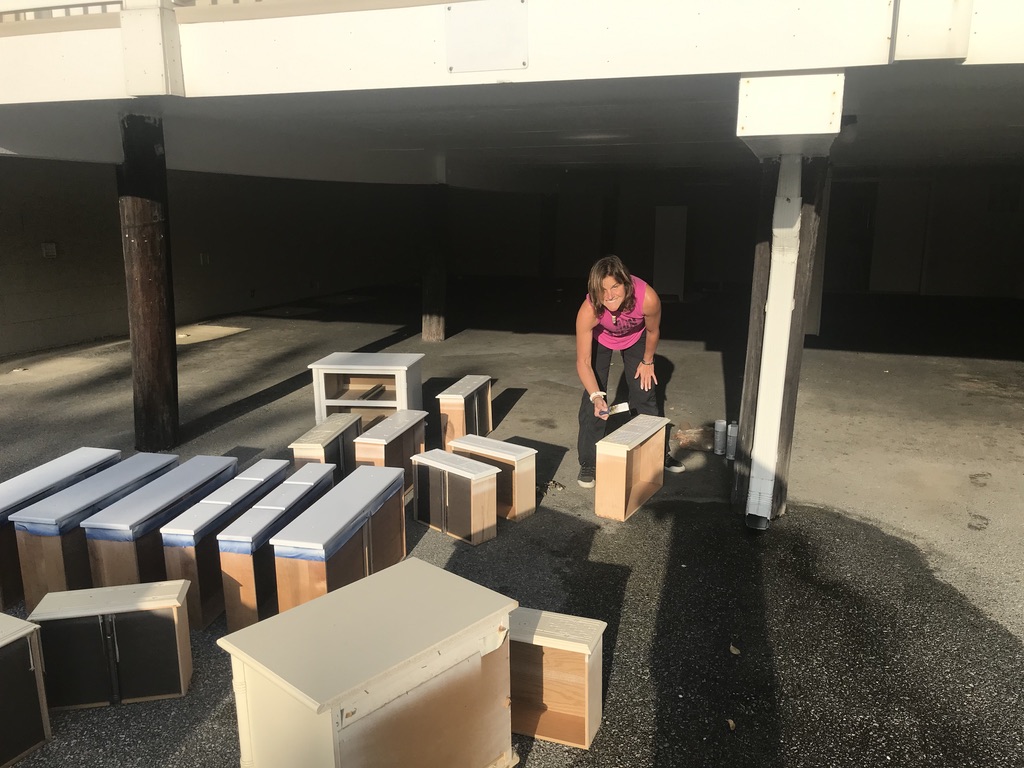 Furniture drawers being painted outdoors
