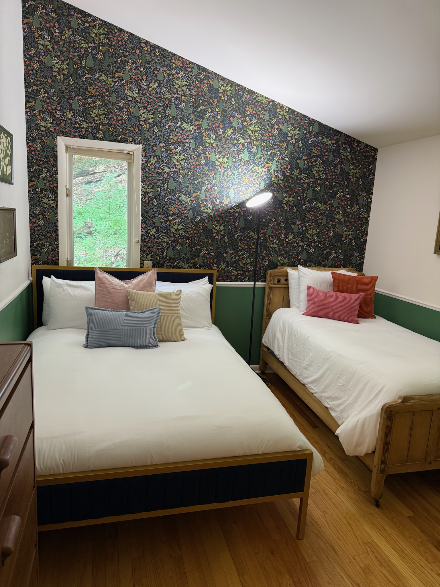 Guest bedroom with woodland wallpaper and comfortable beds